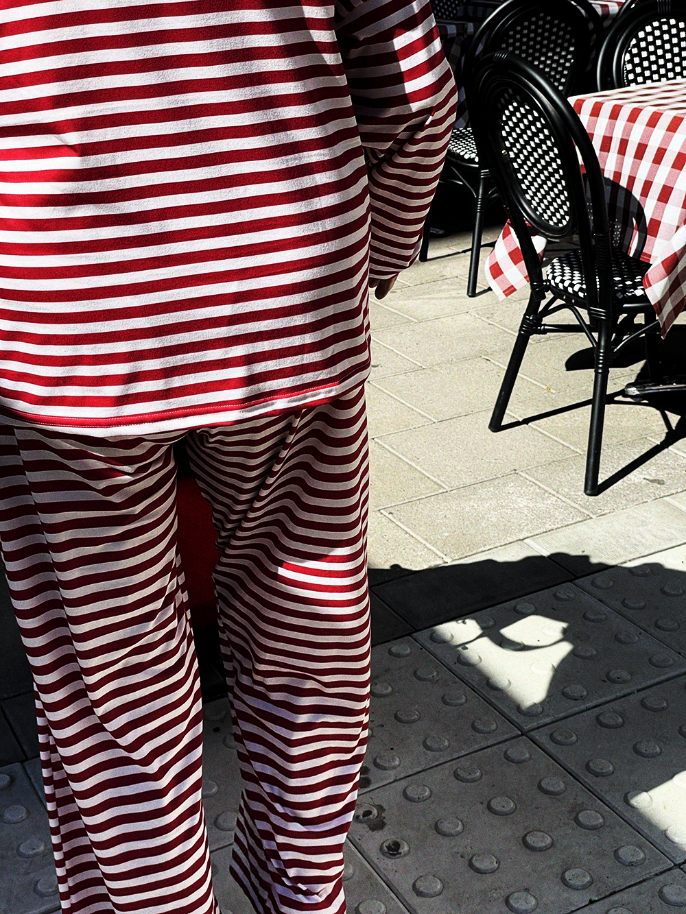 Red and white striped outfit outside a cafe